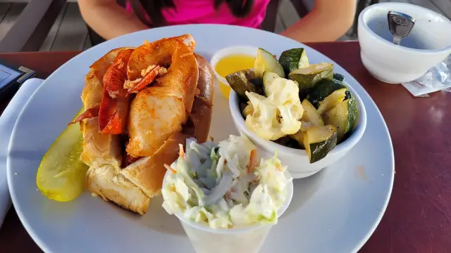 skipper chowder lobster on a bun with salad