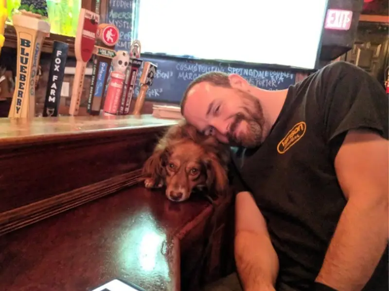 Man with a dog in a Boston pub