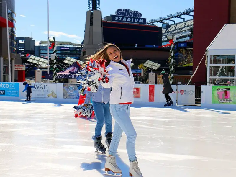 Girl having fun and ice skating at Patriot Place, MA