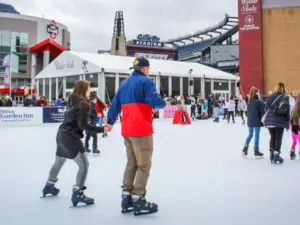 A couple ice skating at Patriot Place, MA